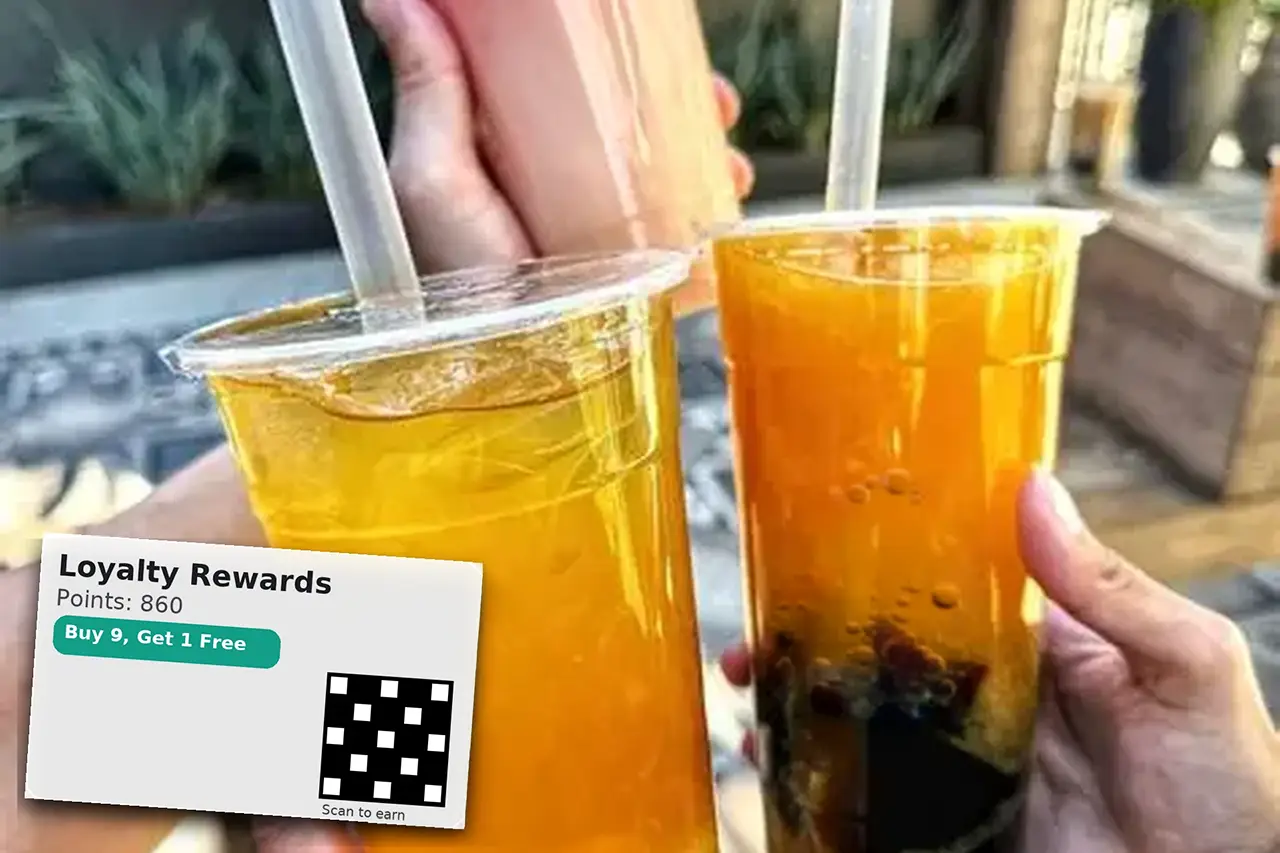 Customers enjoying beverages while a loyalty program experience is displayed